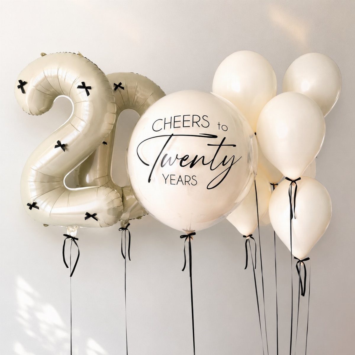 White and cream balloons including a foil number 20 and anniversary text.