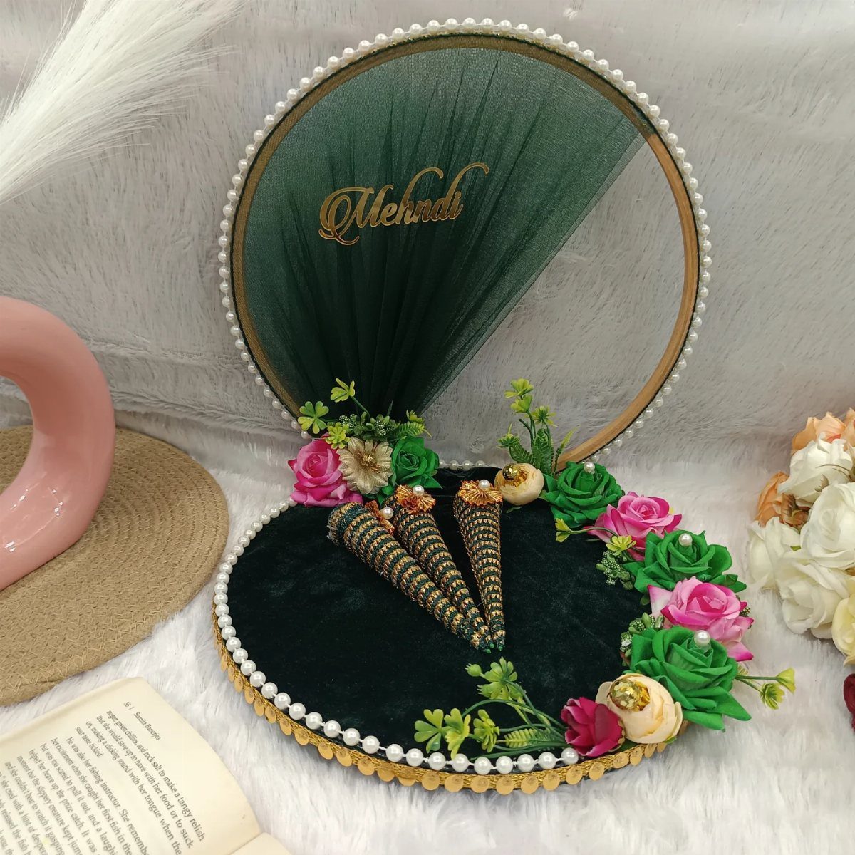 Green and gold velvet mehndi platter with flowers, henna cones, and pearl trim.